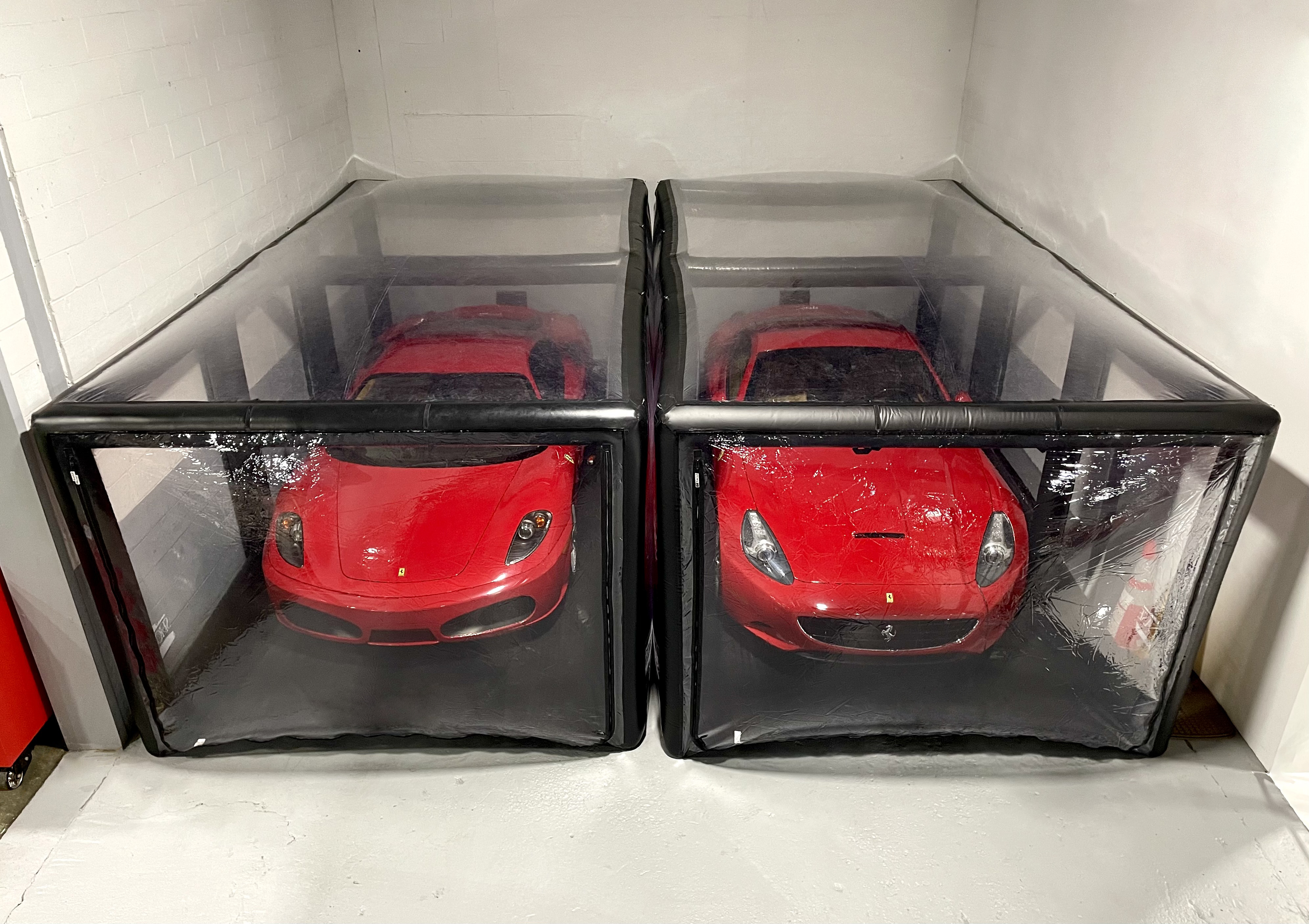 Two Ferraris in storage container