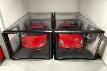 Two Ferraris in storage container